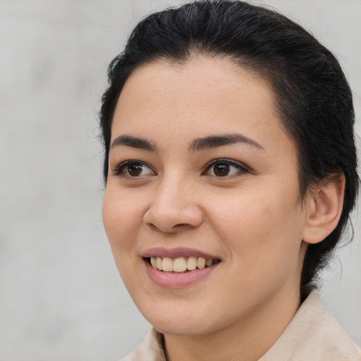 Joyful latino young-adult female with medium  brown hair and brown eyes