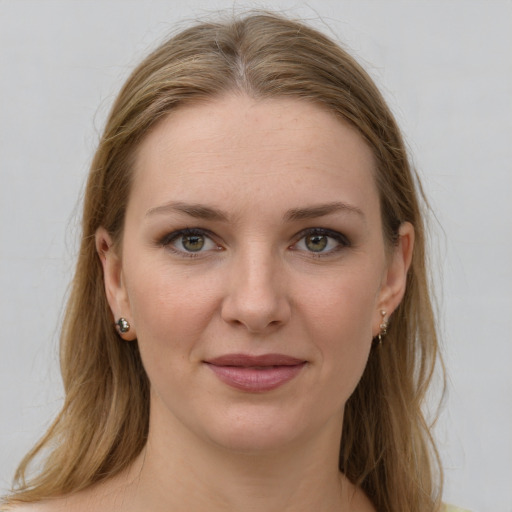 Joyful white young-adult female with long  brown hair and green eyes