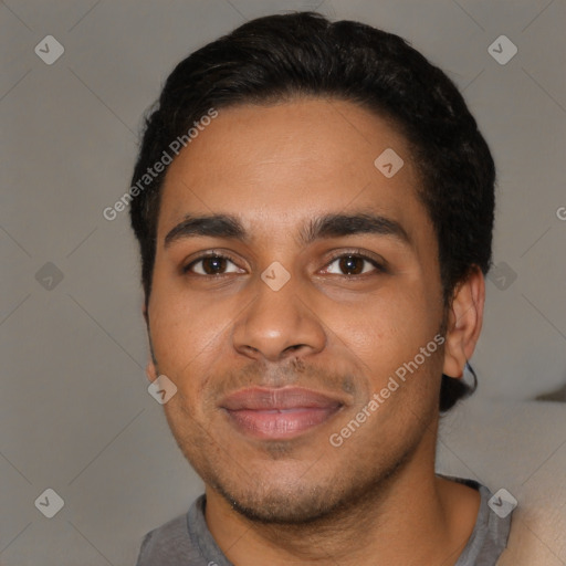 Joyful latino young-adult male with short  black hair and brown eyes