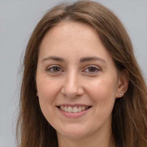 Joyful white young-adult female with long  brown hair and brown eyes