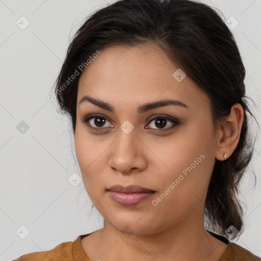 Joyful latino young-adult female with medium  brown hair and brown eyes