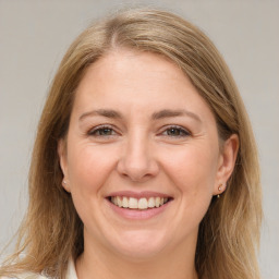 Joyful white adult female with medium  brown hair and brown eyes