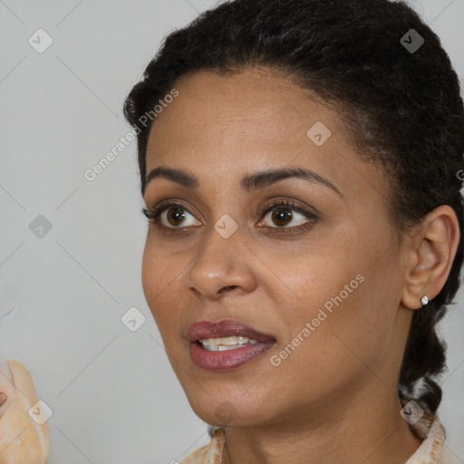 Joyful black young-adult female with short  black hair and brown eyes