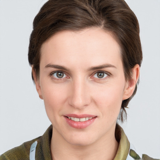 Joyful white young-adult female with short  brown hair and grey eyes