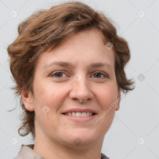 Joyful white adult female with short  brown hair and grey eyes