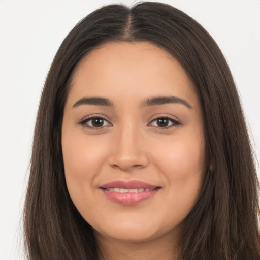 Joyful latino young-adult female with long  brown hair and brown eyes