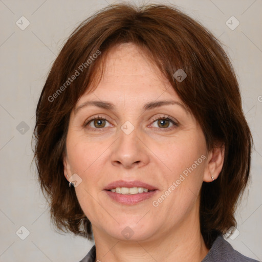 Joyful white adult female with medium  brown hair and grey eyes