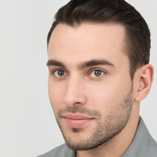 Joyful white young-adult male with short  brown hair and brown eyes