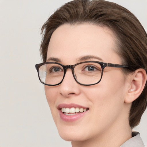 Joyful white young-adult female with medium  brown hair and blue eyes