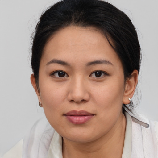 Joyful asian young-adult female with medium  brown hair and brown eyes