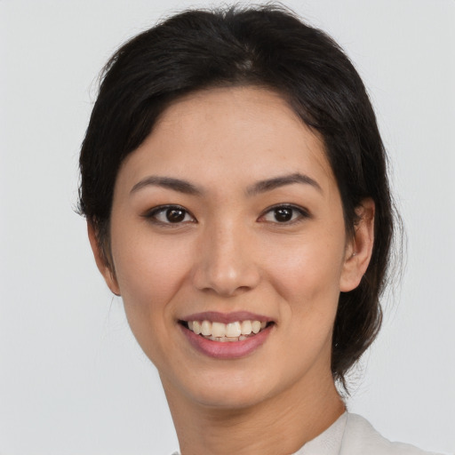 Joyful white young-adult female with medium  black hair and brown eyes