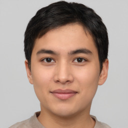 Joyful asian young-adult male with short  brown hair and brown eyes