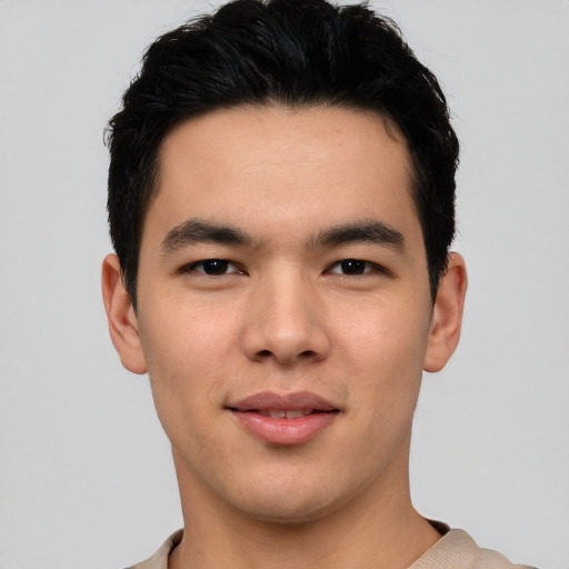 Joyful asian young-adult male with short  black hair and brown eyes