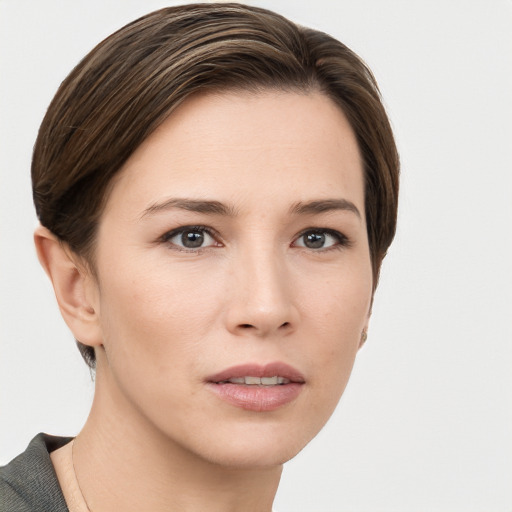 Joyful white young-adult female with short  brown hair and grey eyes