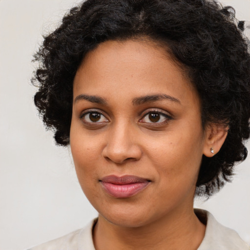 Joyful black young-adult female with medium  black hair and brown eyes
