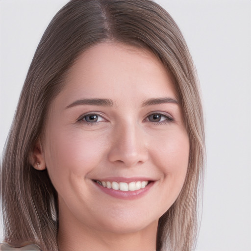 Joyful white young-adult female with long  brown hair and grey eyes