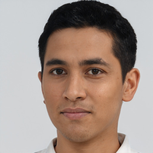 Joyful latino young-adult male with short  black hair and brown eyes