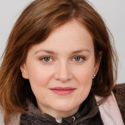 Joyful white young-adult female with medium  brown hair and blue eyes