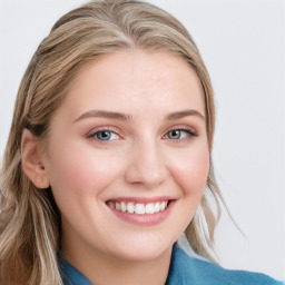 Joyful white young-adult female with long  brown hair and blue eyes