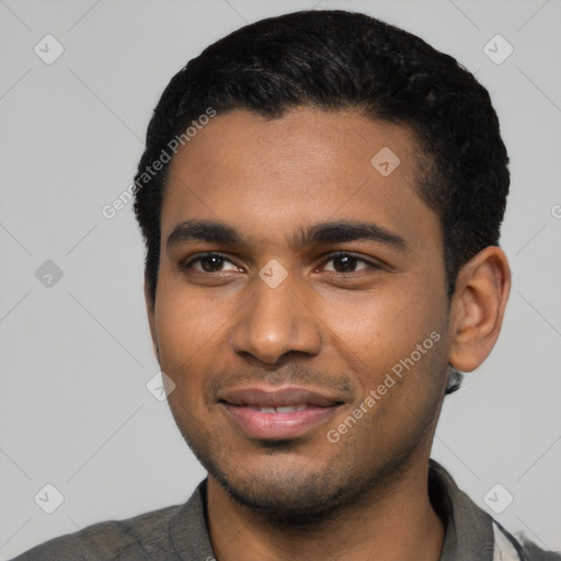 Joyful black young-adult male with short  black hair and brown eyes