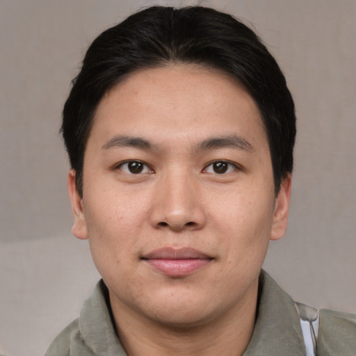 Joyful asian young-adult male with short  brown hair and brown eyes