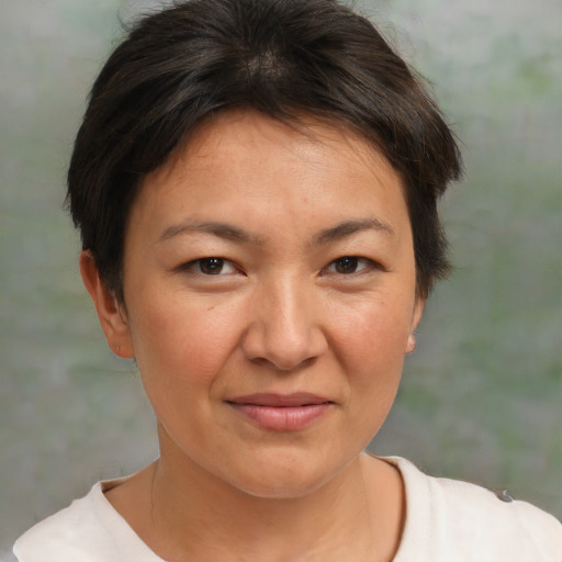 Joyful white adult female with short  brown hair and brown eyes