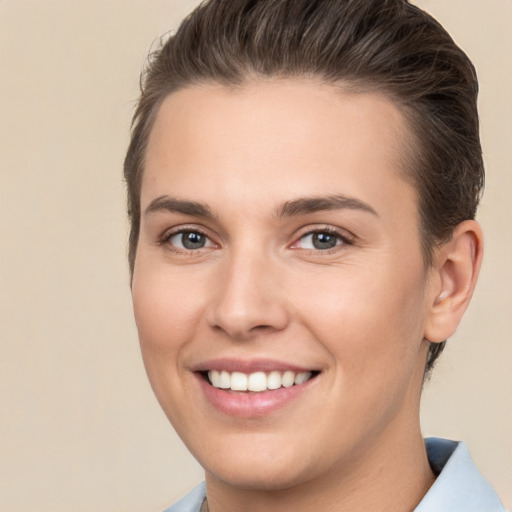 Joyful white young-adult female with short  brown hair and brown eyes