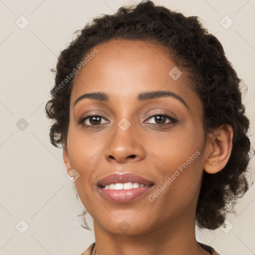 Joyful black young-adult female with long  brown hair and brown eyes