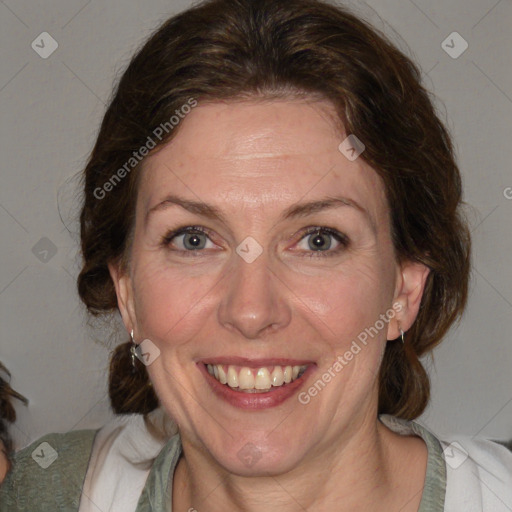 Joyful white adult female with medium  brown hair and blue eyes