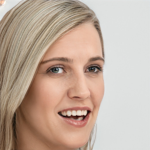 Joyful white young-adult female with long  brown hair and blue eyes