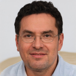 Joyful white adult male with short  brown hair and brown eyes
