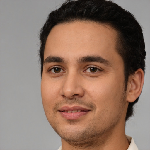 Joyful white young-adult male with short  black hair and brown eyes