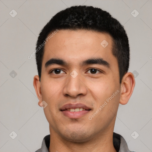 Joyful latino young-adult male with short  black hair and brown eyes