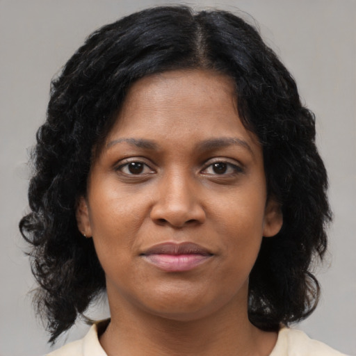 Joyful black young-adult female with medium  brown hair and brown eyes