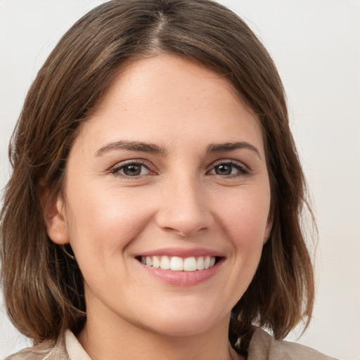 Joyful white young-adult female with medium  brown hair and grey eyes