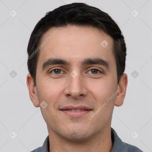 Joyful white young-adult male with short  black hair and brown eyes