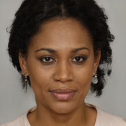 Joyful black adult female with medium  brown hair and brown eyes