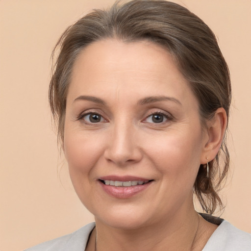 Joyful white adult female with medium  brown hair and brown eyes