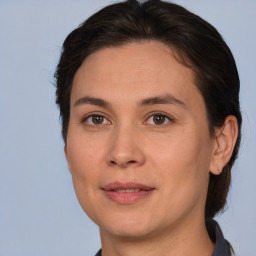 Joyful white adult female with medium  brown hair and brown eyes