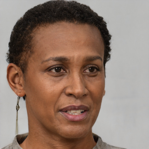 Joyful black adult female with short  brown hair and brown eyes