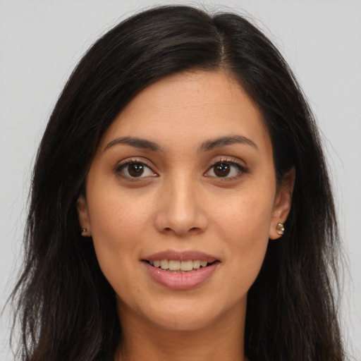 Joyful white young-adult female with long  brown hair and brown eyes
