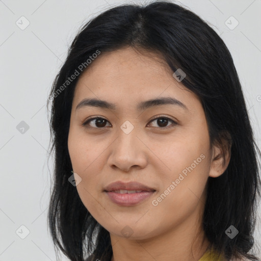 Joyful latino young-adult female with long  brown hair and brown eyes