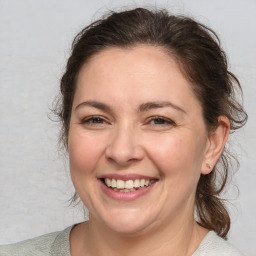 Joyful white adult female with medium  brown hair and brown eyes