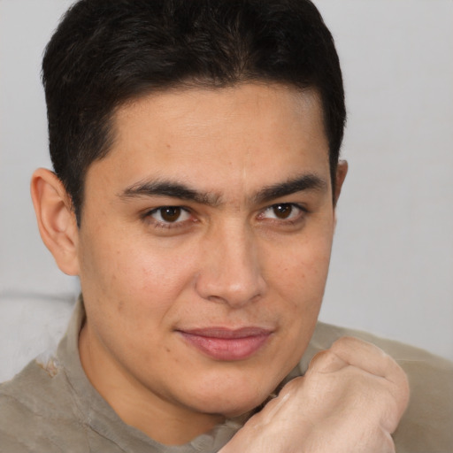 Joyful latino young-adult male with short  brown hair and brown eyes