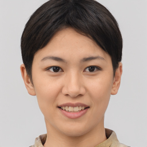 Joyful asian young-adult female with short  brown hair and brown eyes