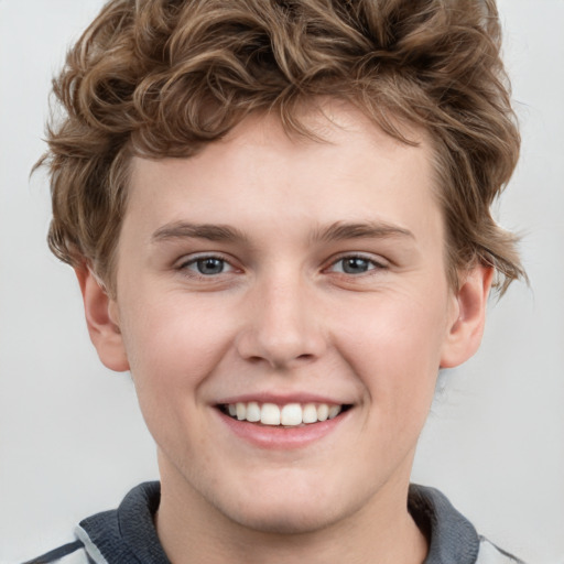 Joyful white child male with short  brown hair and grey eyes