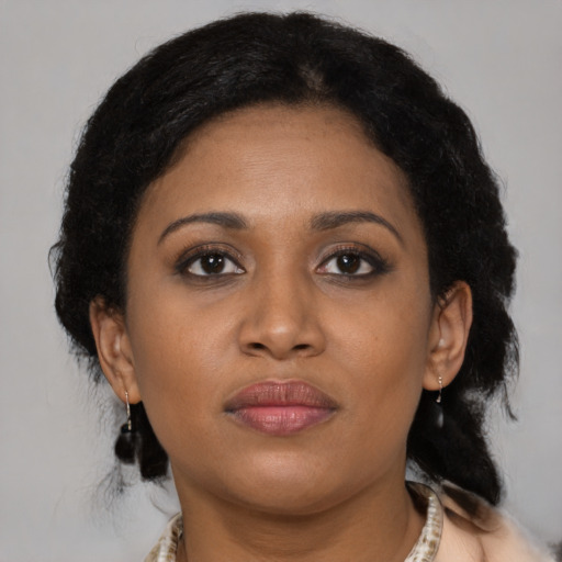 Joyful latino adult female with medium  brown hair and brown eyes