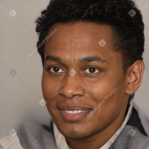 Joyful black adult male with short  black hair and brown eyes
