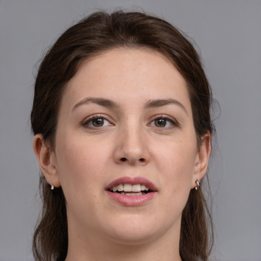 Joyful white young-adult female with medium  brown hair and grey eyes