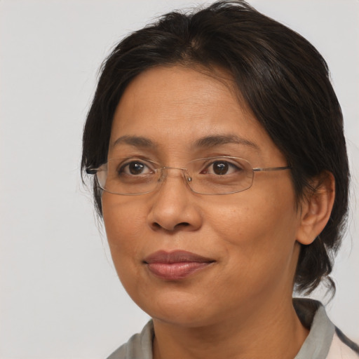 Joyful latino adult female with medium  brown hair and brown eyes